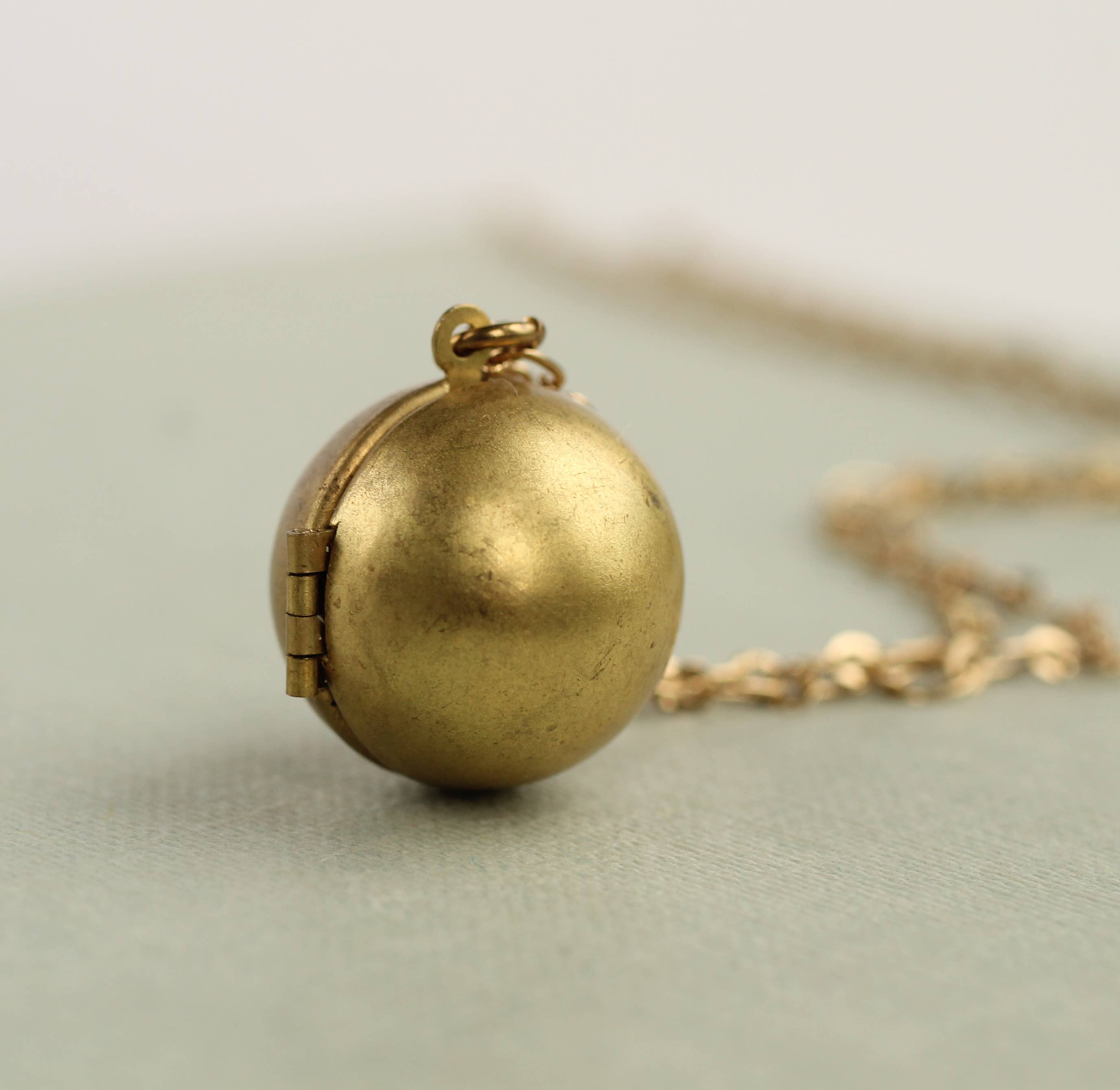 Silk Purse, Sow’s Ear Brass Sphere Locket Necklace