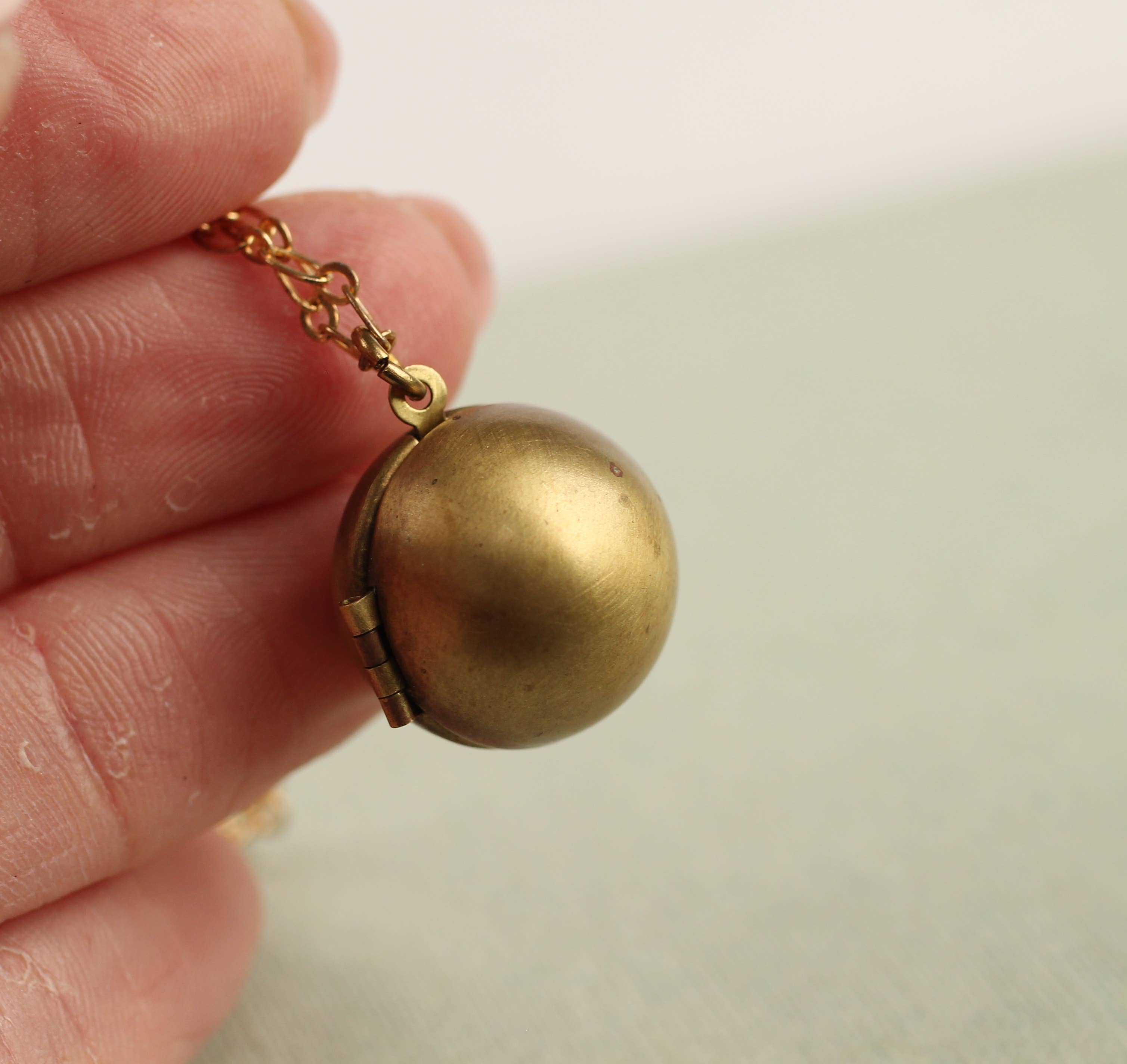 Silk Purse, Sow’s Ear Brass Sphere Locket Necklace